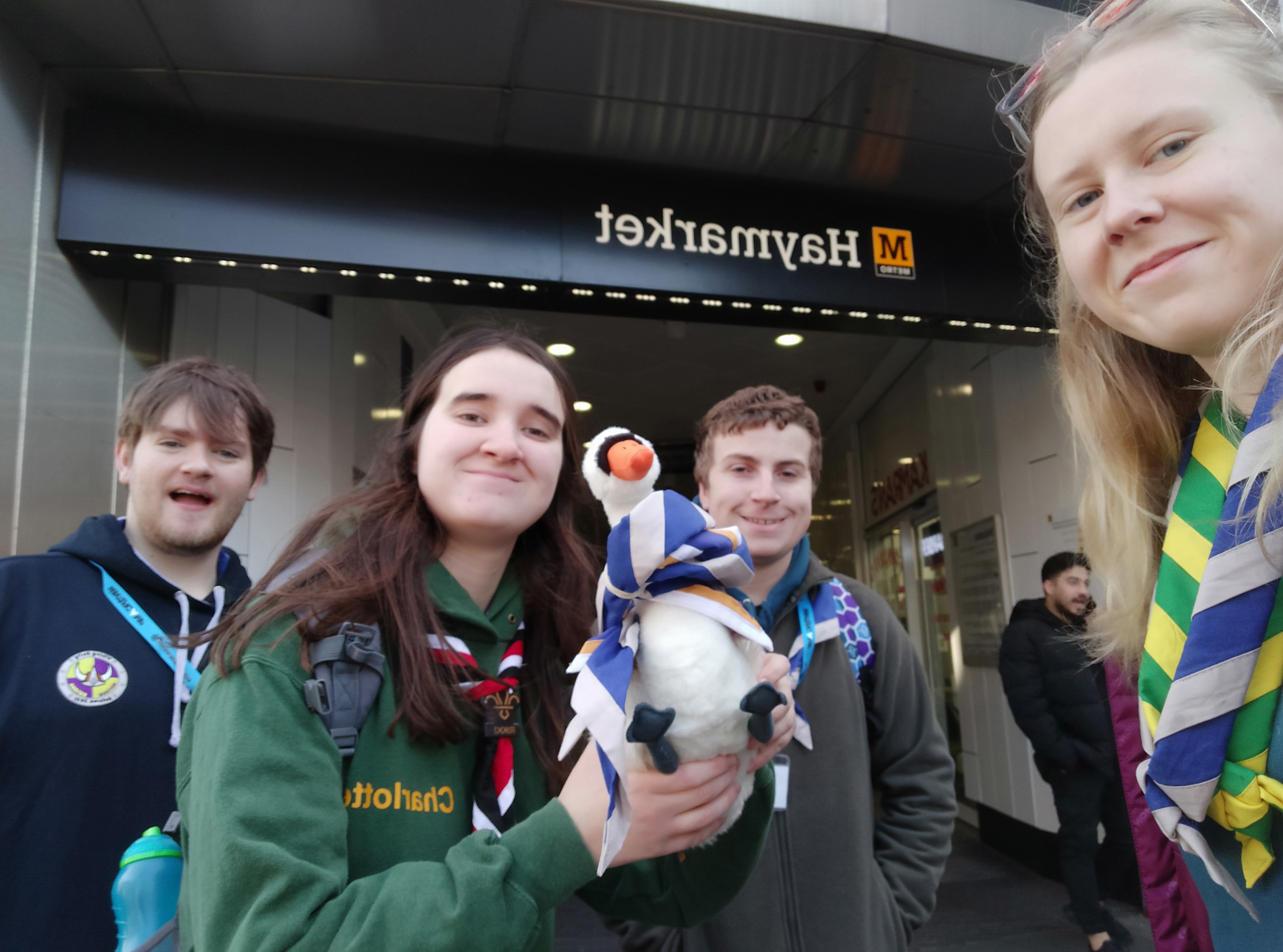 Small group photo from the Monopoly Run activity, of a team outside Haymarket Metro Station